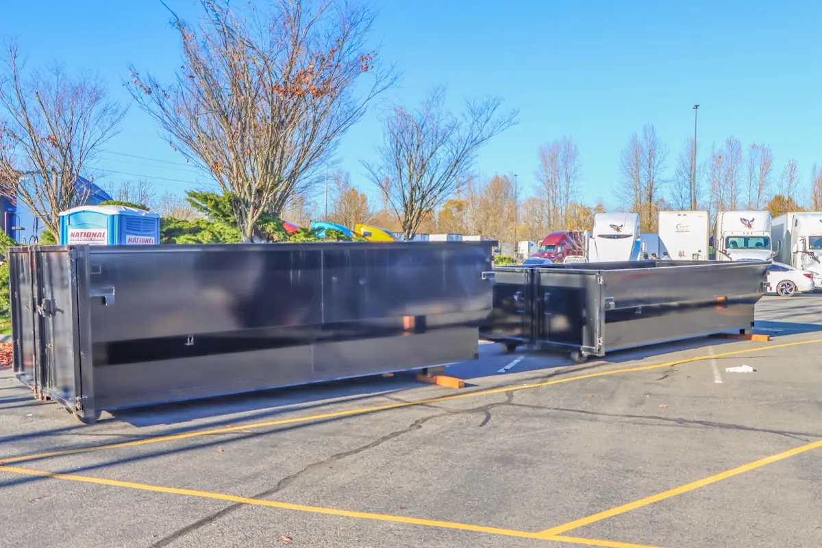 Professional dumpster rental service with roll-off container on residential driveway in West Vincent